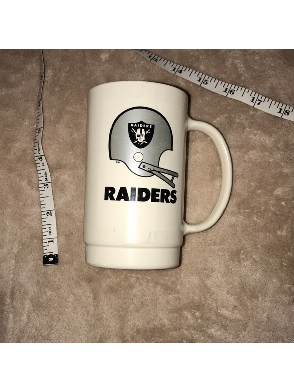6” tall White plastic Raiders souvenir Mug with Silver & Black Helmet Logo